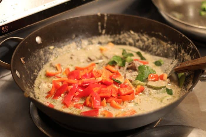 thai green curry cooking in a pan