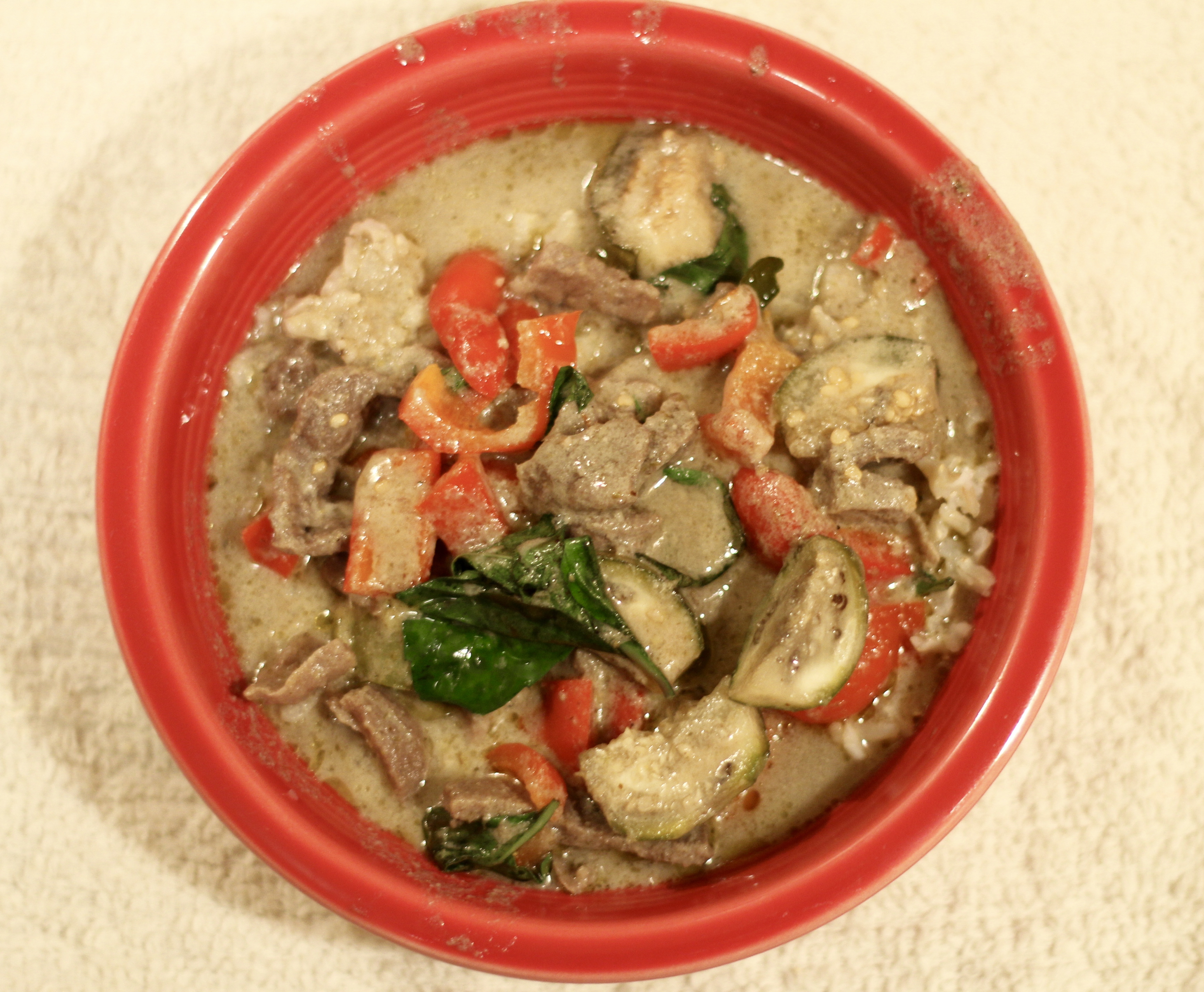 green curry with beef in a scarlet fiestware bowl 