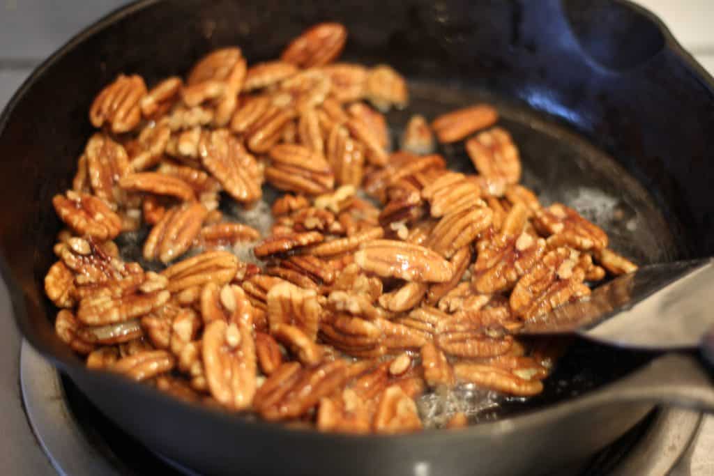 Melted butter over pecans, just before adding the sugar and cream. 