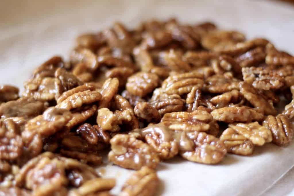 quick and easy candied pecans cooling on waxed paper