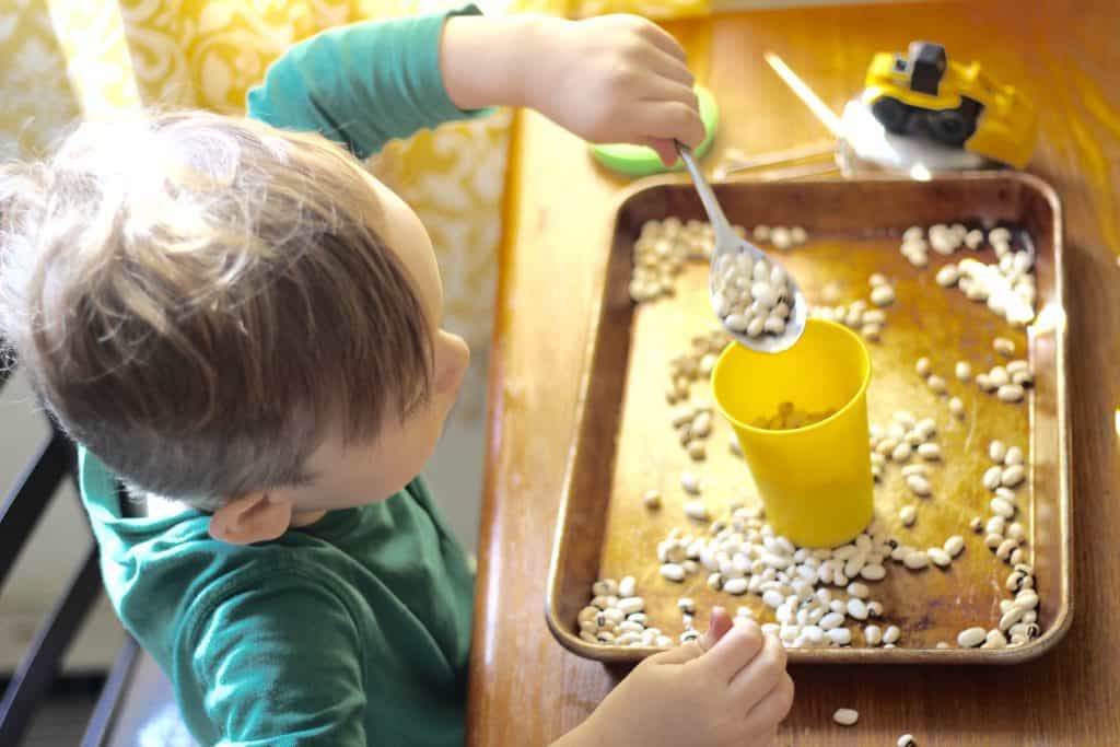 Scooping beans toddler activity