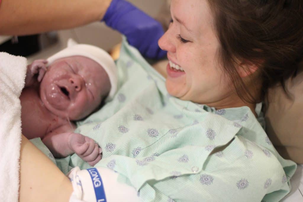 mom meeting her third baby just after delivery