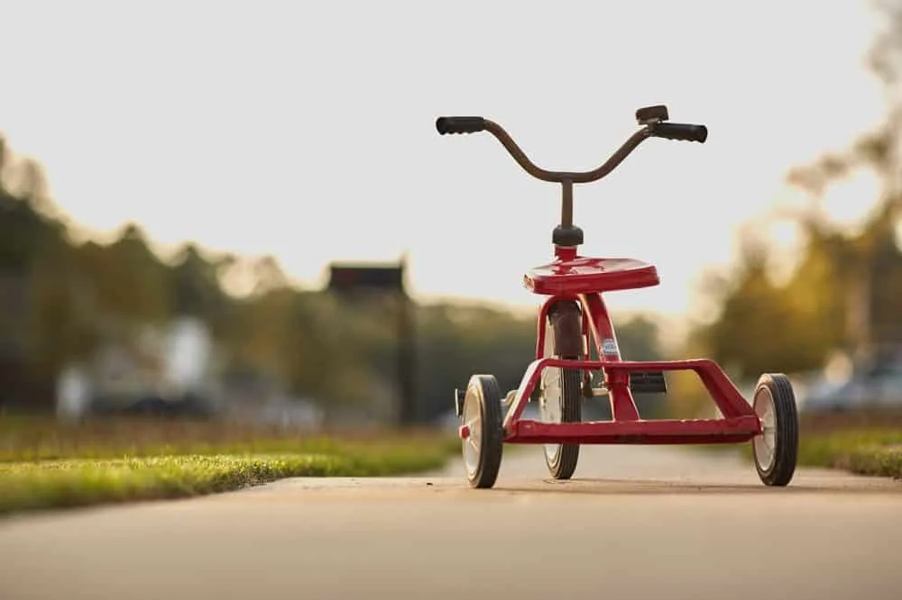 photo of a red tricycle used as cover photo for how to homeschool preschool post