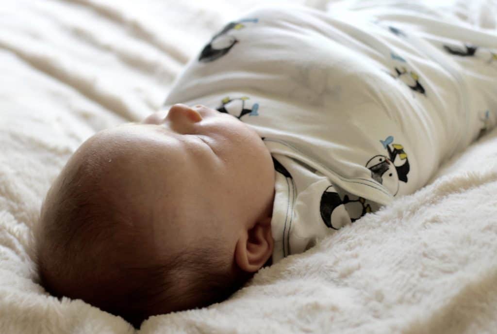 Newborn photo angled shot in swaddle blanket