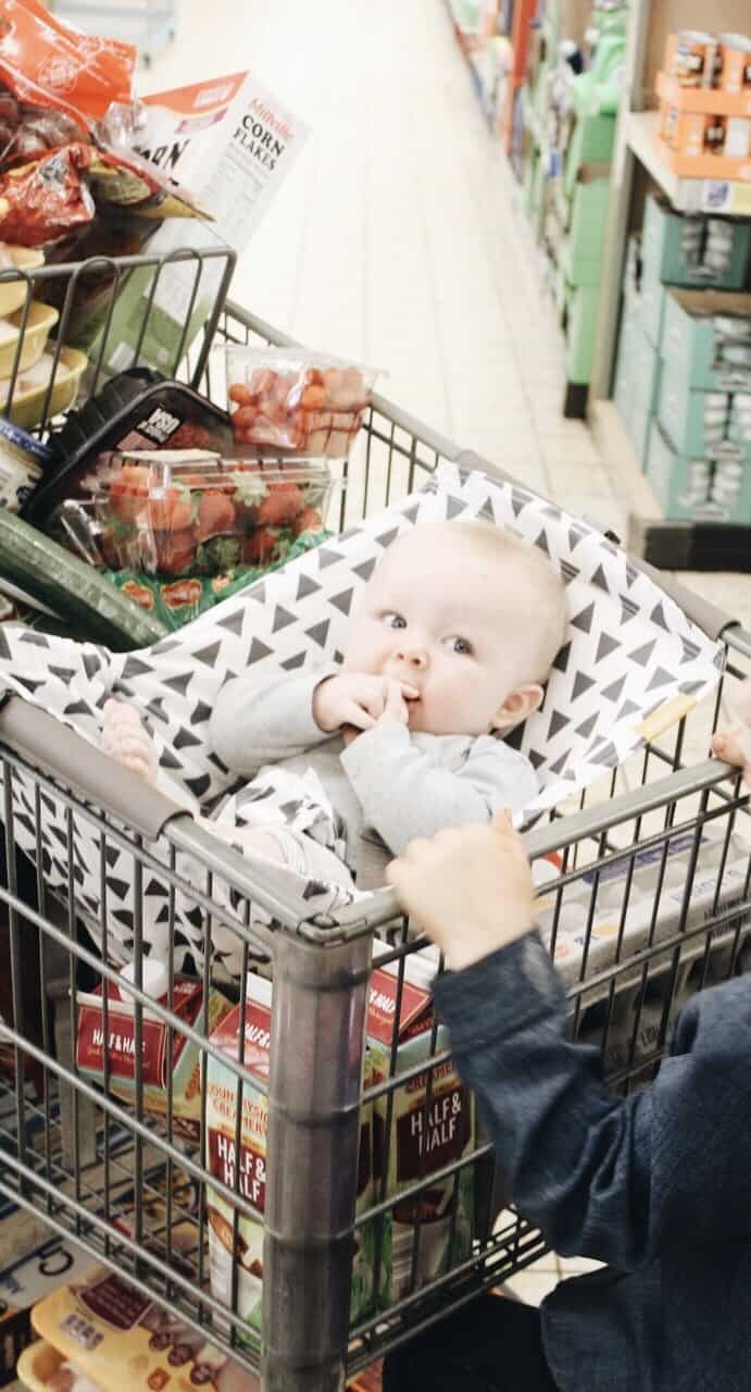 Shopping cart full of groceries with the baby in a Binxy Baby Hammock