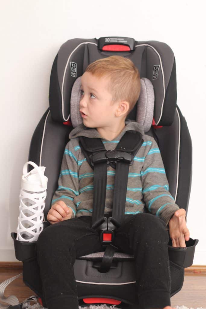 grace slim fit all in one review; boy sitting buckled up in a grey narrow car seat