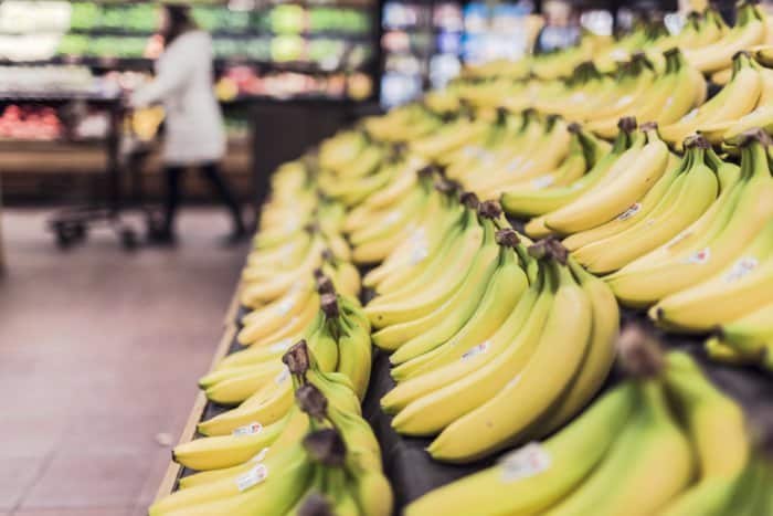 a close up of the banana isle at the store full of yellow bananas