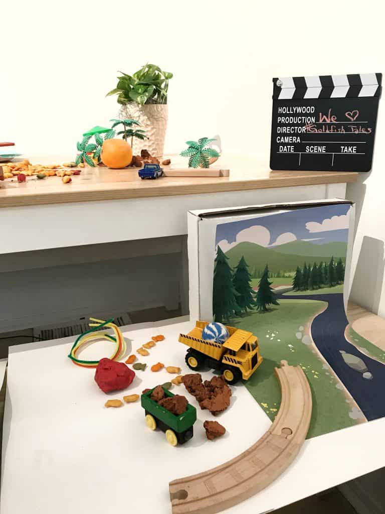 all the materials needed to make a stop-motion video with Goldfish crackers including a backdrop and set made of dirt, train, tracks, and dump truck. 