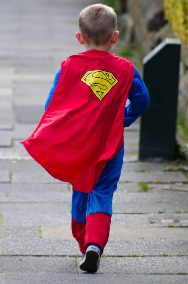 potty training tips for boys, everything you need to know plus tricks for when it's not working. boy wearing a superman costume.