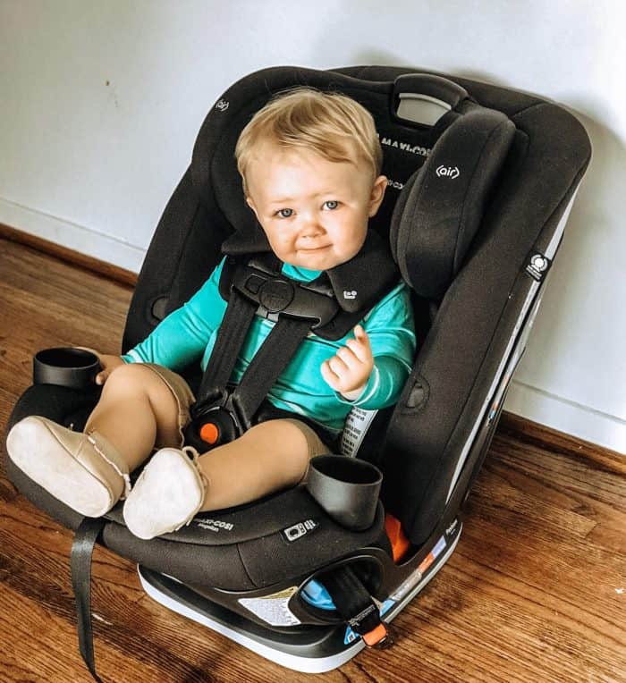 baby boy sitting in a new Black Maxi-Cosi Car Seat wearing a teal shirt