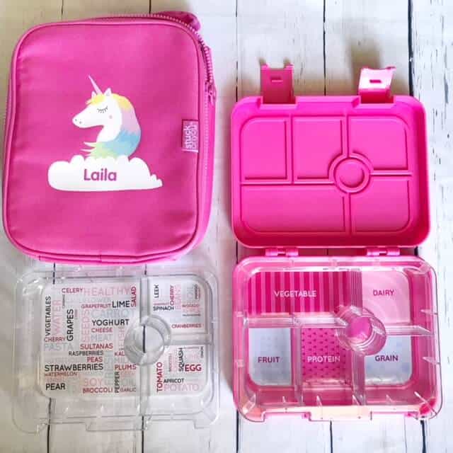 hot pink bento box with clear plastic tray, and a matching hot pink cooler with unicorn on the front.