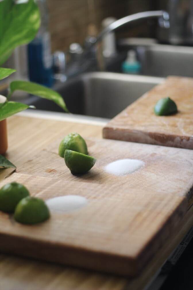 Salt and lime juice on a wooden cutting board used to remove garlic and onion smell