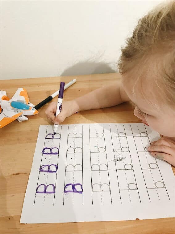 preschooler tracing the letter B uppercase and lowercase while learning to write