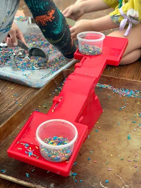 rice sensory bin activity using a scale