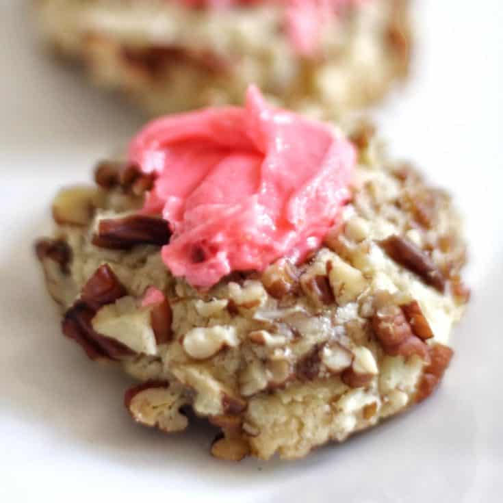 pink vanilla buttercream thumbprint cookie rolled in pecans