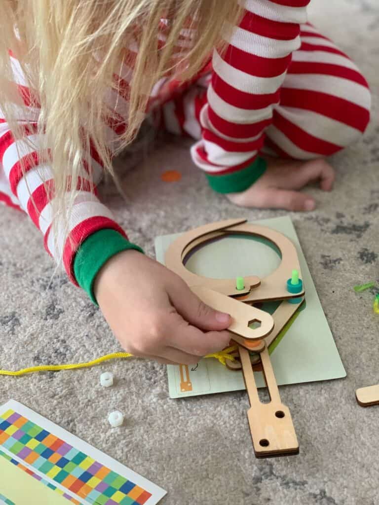 a girl building a kiwi crate mechanical claw