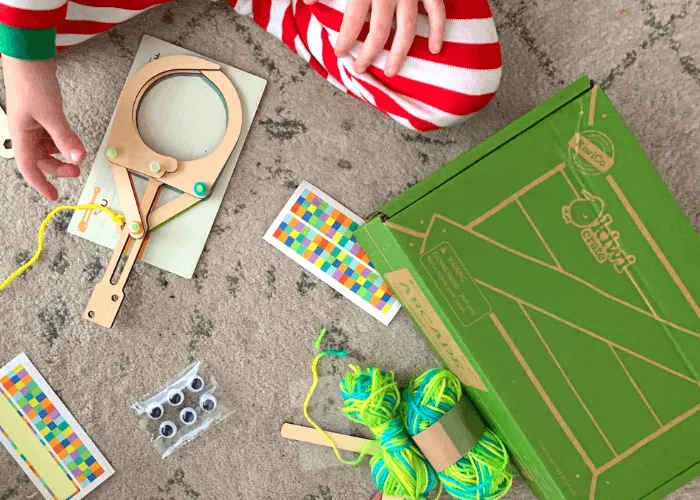 kid building a kiwi crate mechanical claw