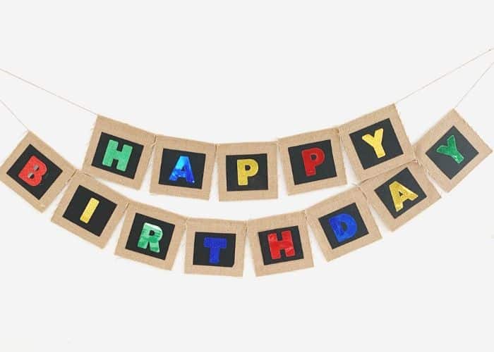 A burlap happy birthday banner hung on the wall