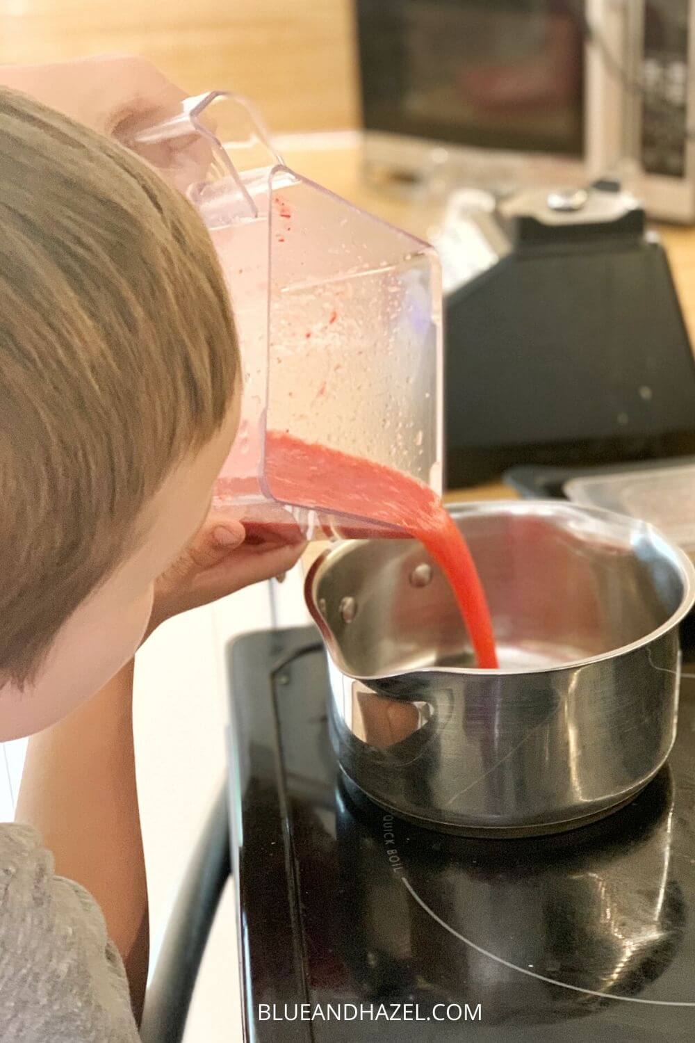 Making strawberry freezer jam by mixing and pouring into a pot before adding pectin.