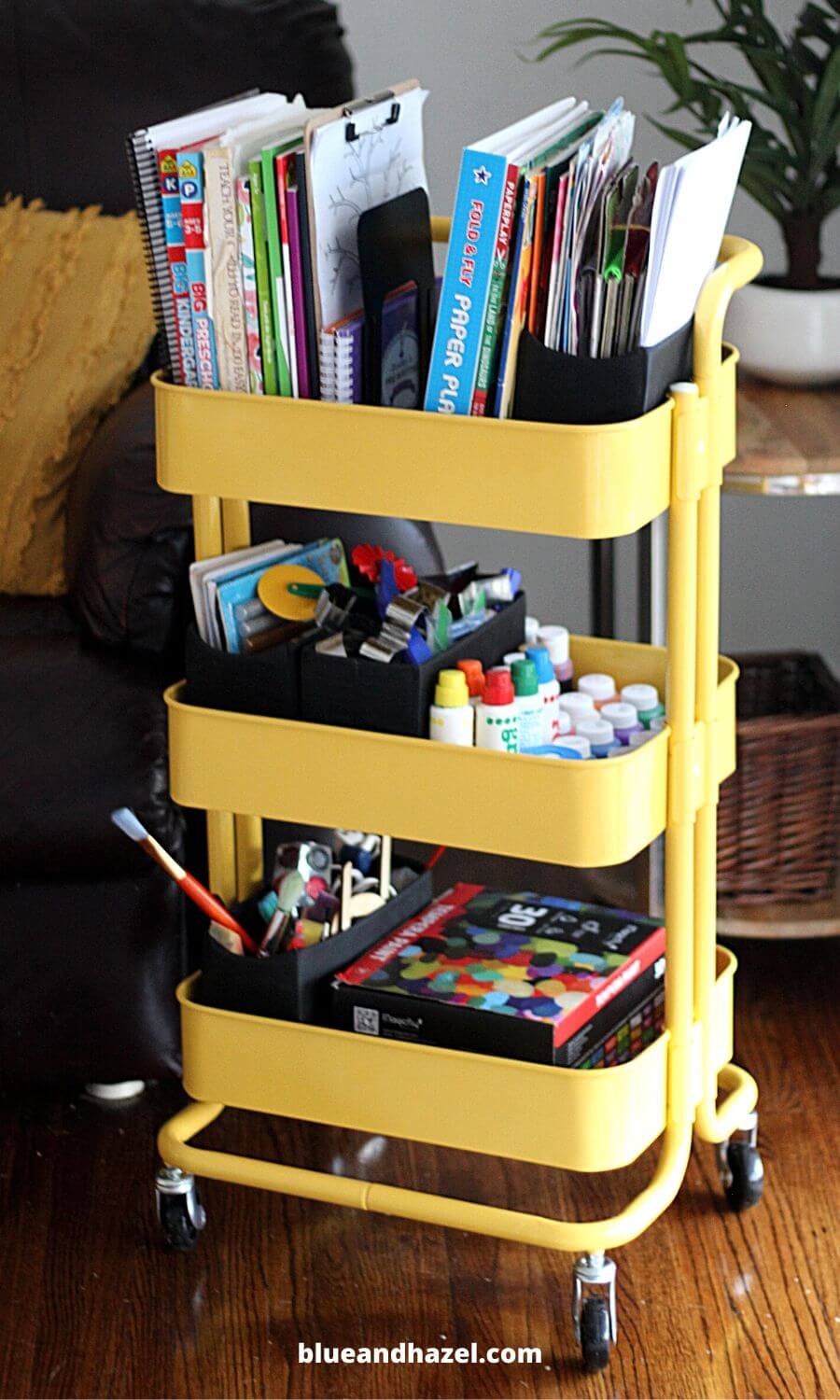 Yellow metal rolling cart used to organize homeschool supplies. 