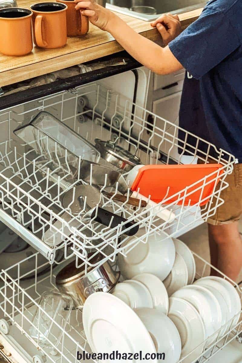 A 7 year old unloading the dishwasher, an age appropriate chore.