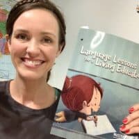 language lessons for a living education level 1 book being held up and reviewed by a homeschool mom