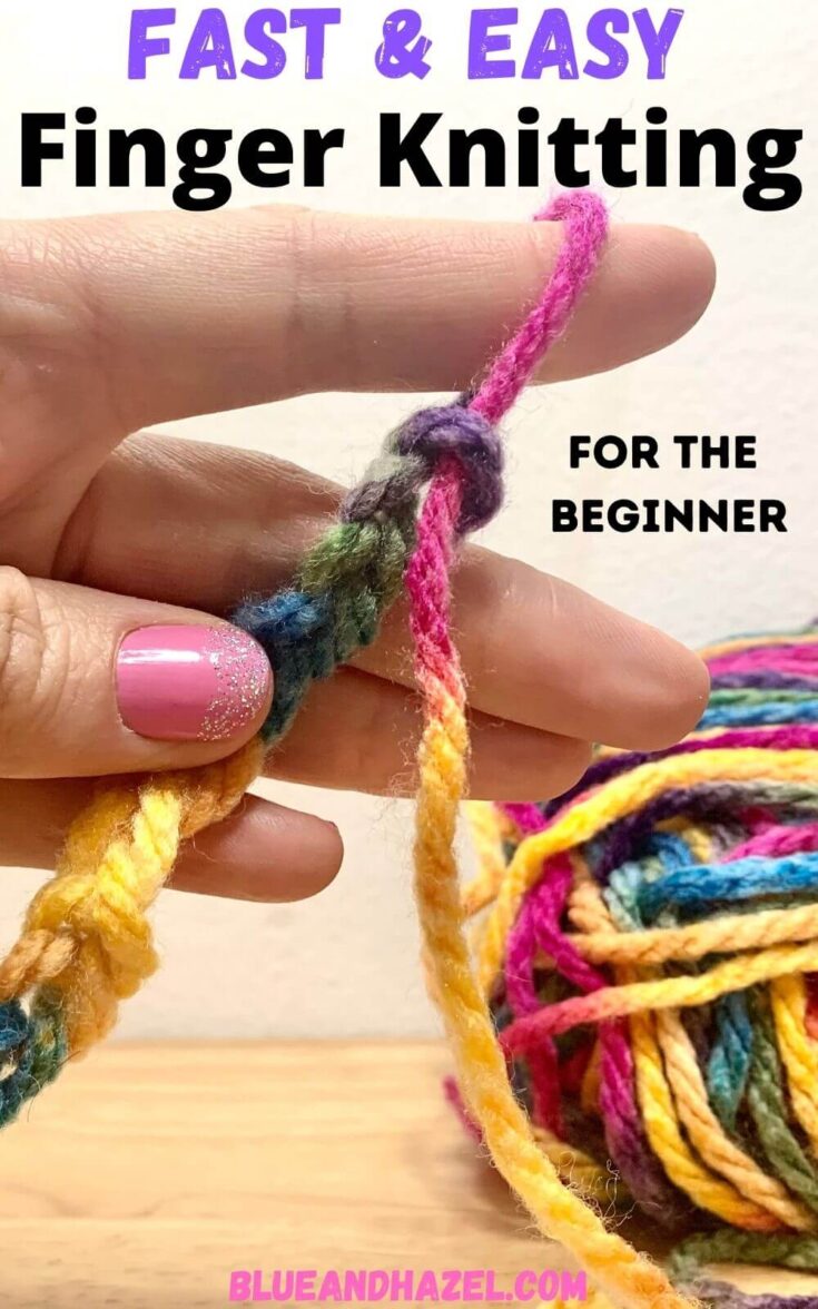 Colorful rainbow yarn being finger knit onto one finger. 