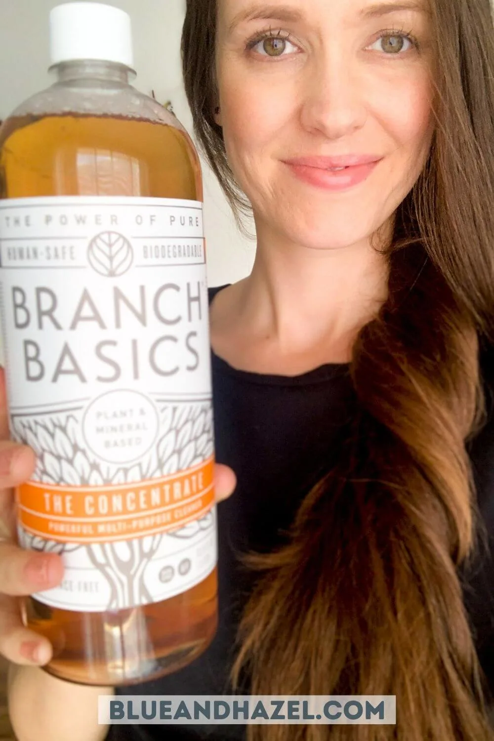 Bottle of Branch Basics Concentrate held by a smiling mom.