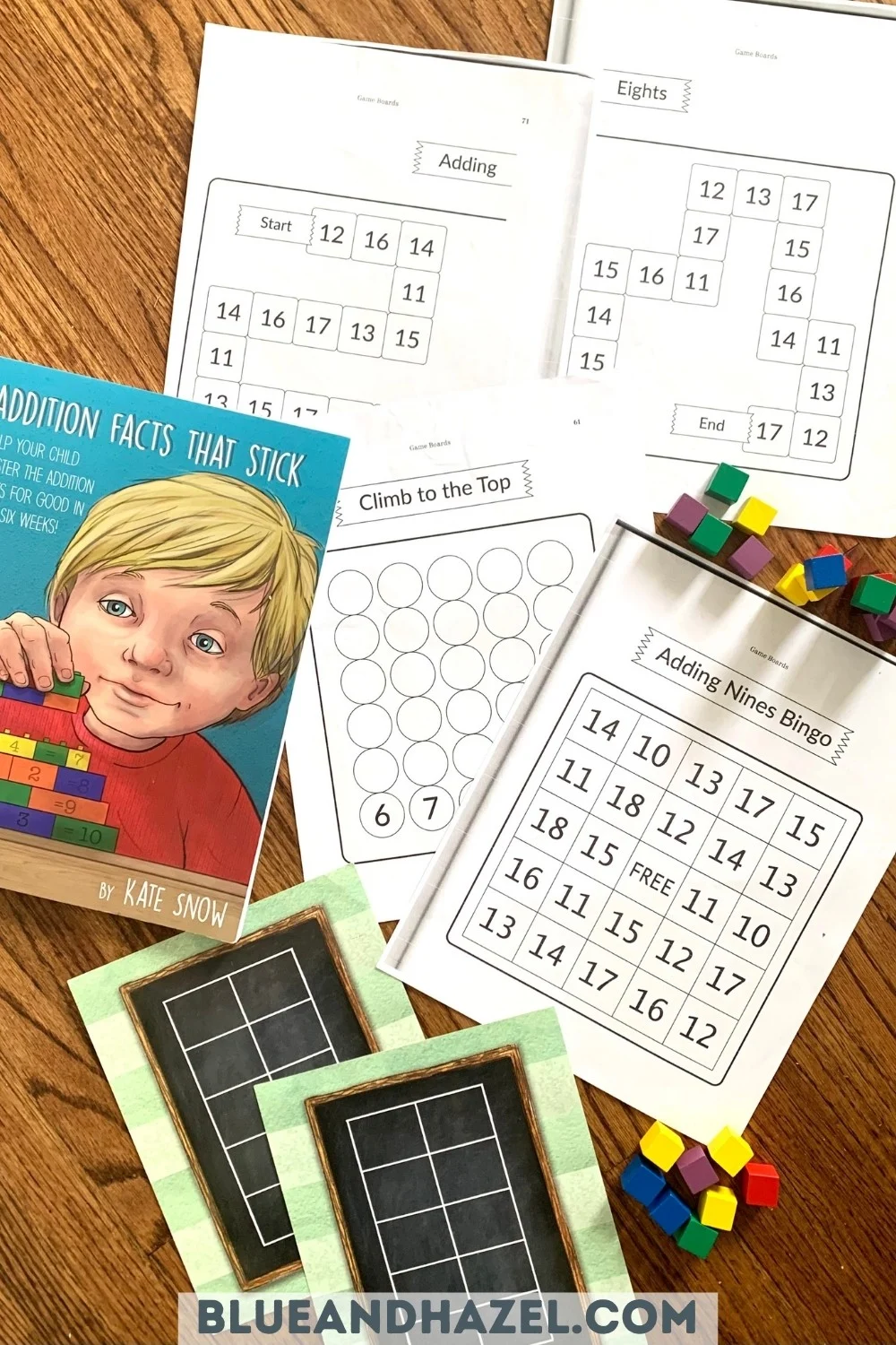 math game worksheets from the book Addition Facts That Stick next to colorful cubes used as counters. 