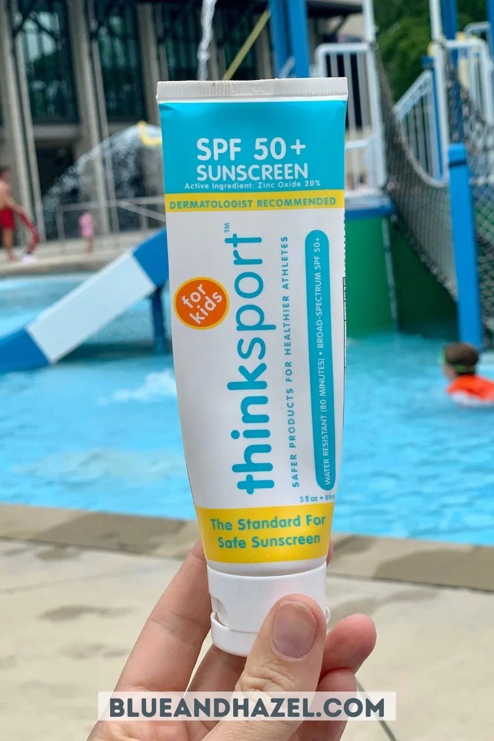 A close up holding Think Sport spf 50 for kids sunscreen. 