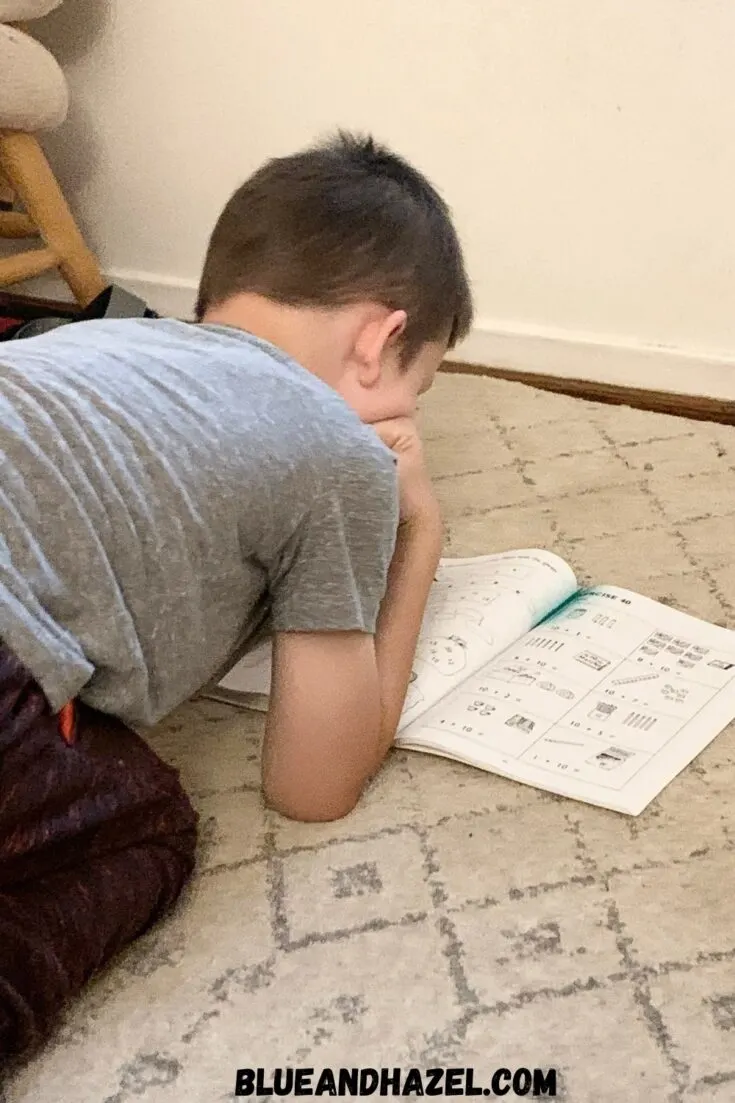 A 1st grade boy completing his homeschool math from the Singapore Math Primary US Edition level 1A.