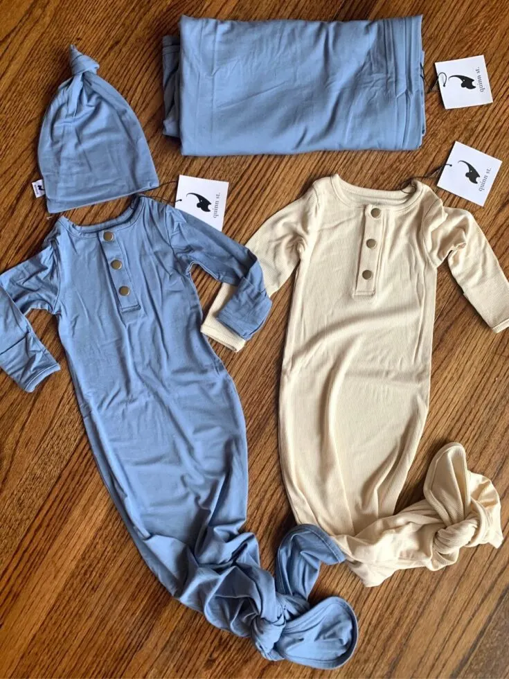 blue and cream newborn onesies with tie bottoms from Quinn St. with hat and matching swaddle.