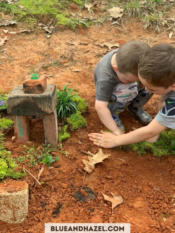 two brothers making a fairy house