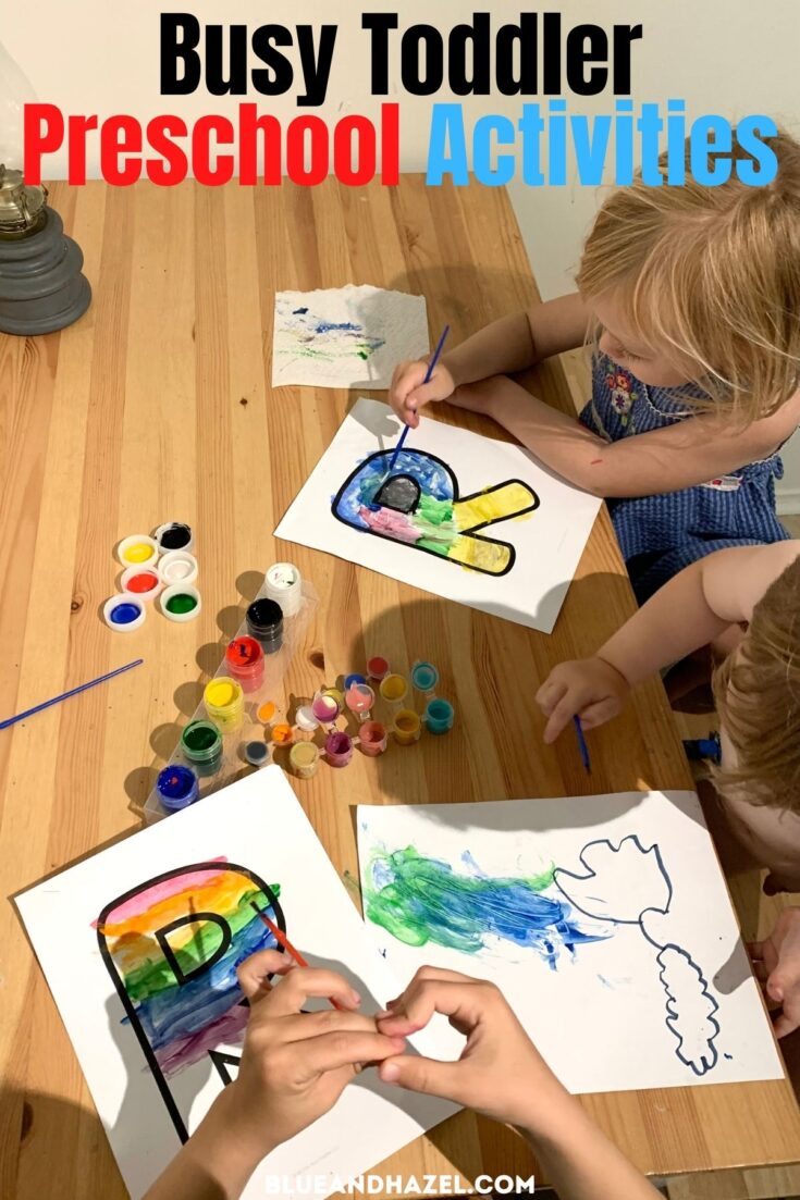 Two toddlers painting a rainbow on the capital letter "R" during preschool at home. 