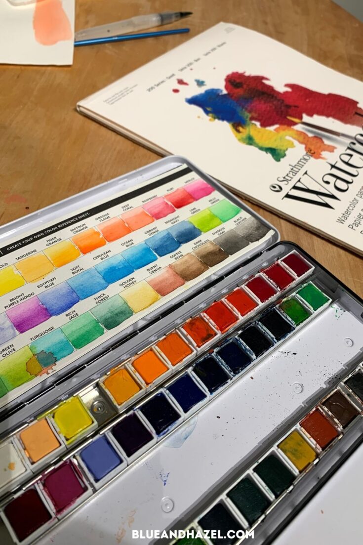 high quality watercolor set with samples of each color on a paper grid.