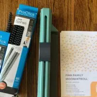 Swingline Proclick next to 2 boxes of black binding spines
