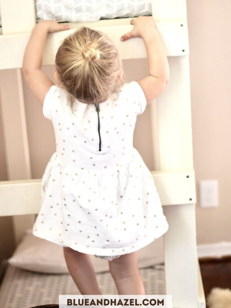 A toddler climbing up onto a bunk bed