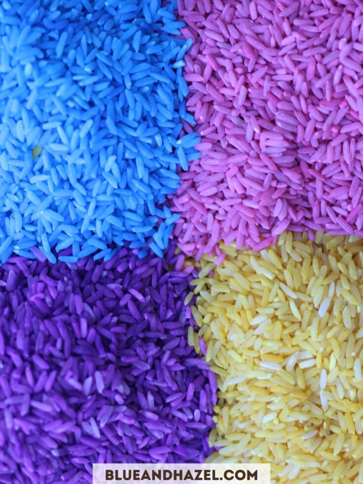 Close up of purple, yellow, blue, and pink dyed rice used for toddler sensory bins. 