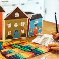 homeschool supplies like colorful popsicle sticks and place value charts on a table