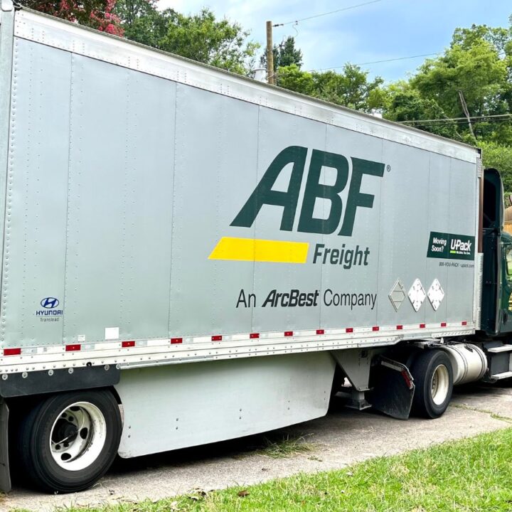 An ABF moving trailer parked in front of a house