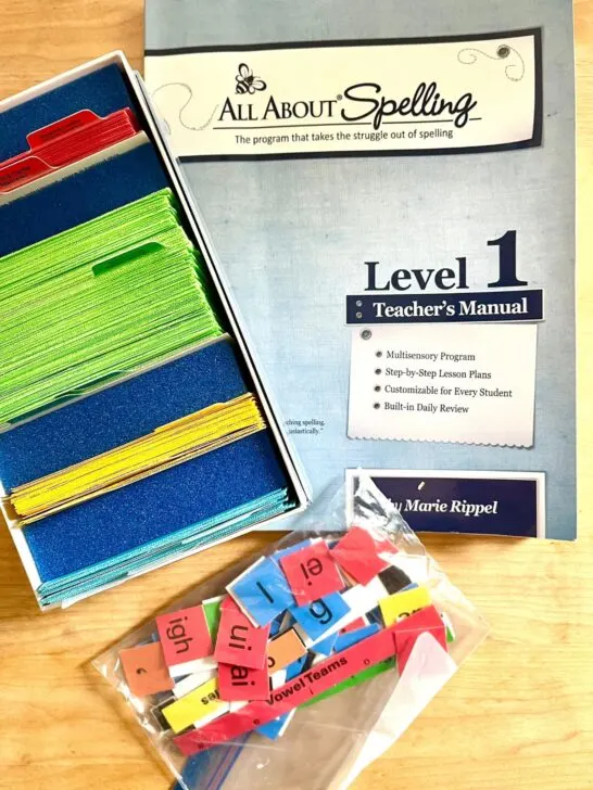All About Spelling level 1 Teacher's manual plus student flashcards organized by color and magnetic alphabet tiles.