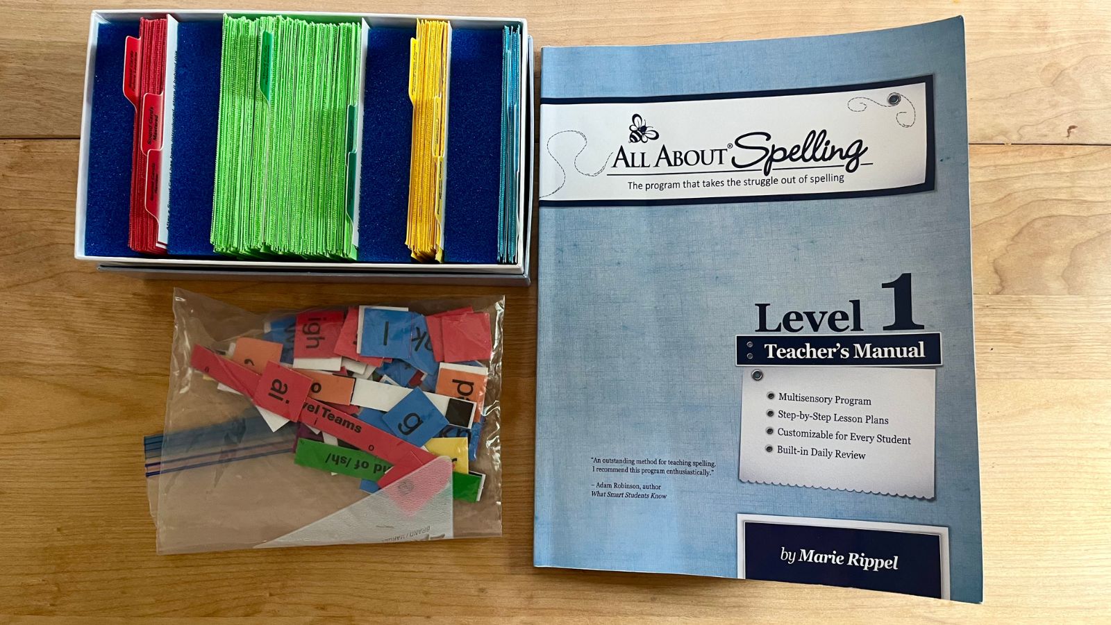 All About Spelling Level 1 materials including the teachers manual, flashcards from the student book, and magnetic tiles