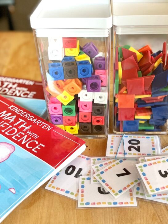 Math cubes and tangrams in plastic jars used with Kindergarten Math With Confidence