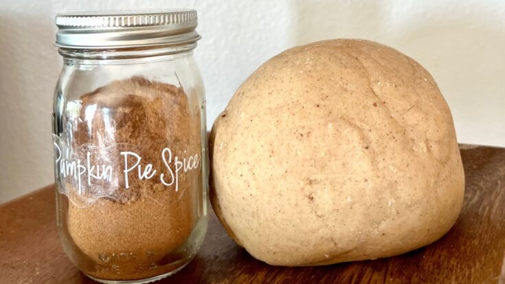 pumpkin spice play dough next to a jar of pumpkin pie spice