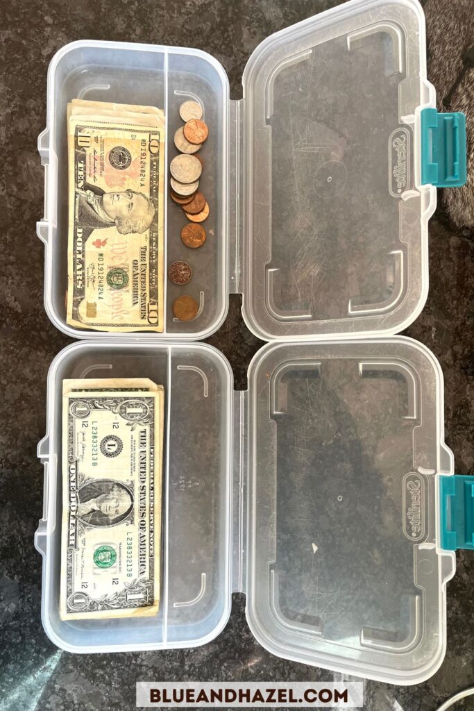 Two thin, plastic containers used to store kid's allowance in leu of a piggy bank. 