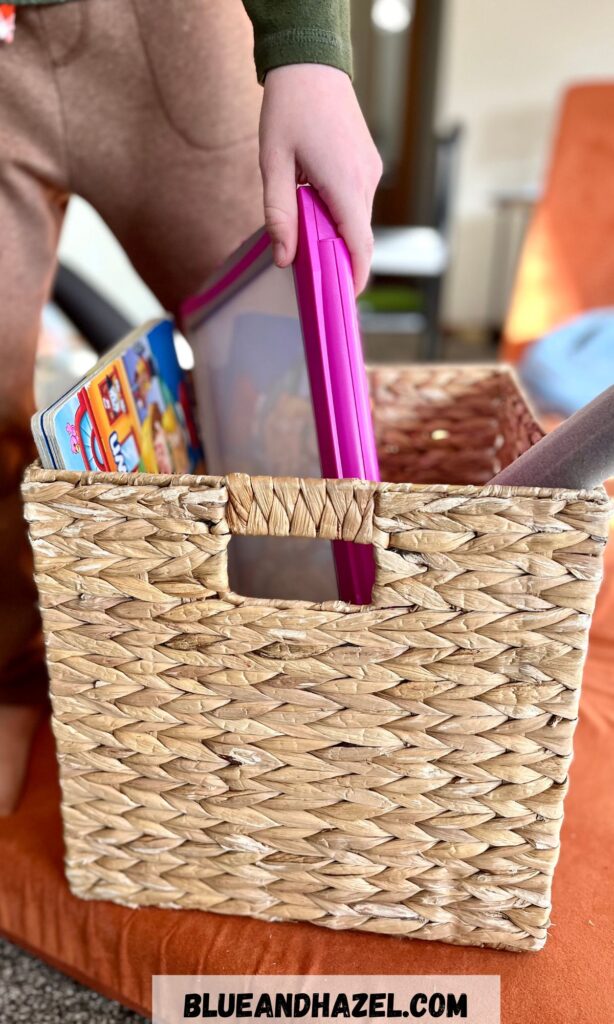 A wicker basket filled with toys for tidying up.