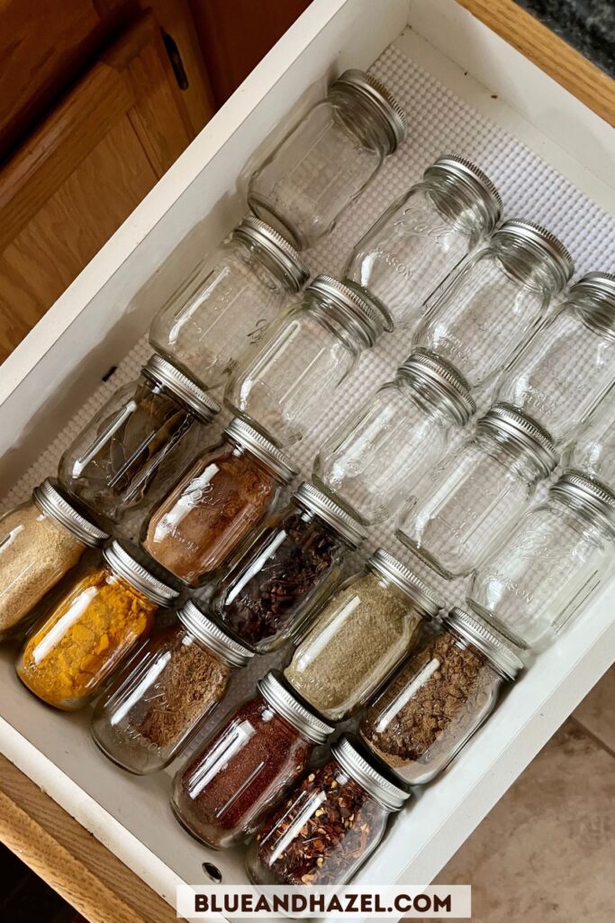 https://blueandhazel.com/wp-content/uploads/2023/01/Spice-Rack-Organization-In-A-Drawer-Using-Mini-Jars-683x1024.jpg