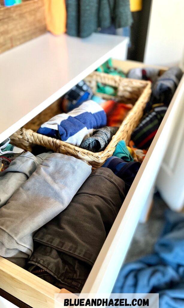 A 9 year olds clothes drawer including folding up pants.