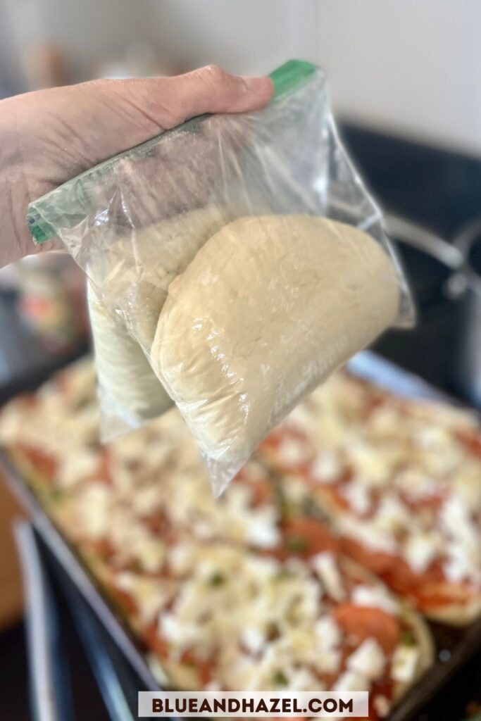 two bags of pizza dough going into the freezer in ziplock bags. 