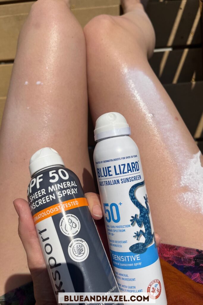 Two types of mineral sunscreen, one sprayed on each leg showing in the picture but not rubbed in yet. The sunscreen sprayed are Blue Lizard SPF 50 sensitive, and ThinkSport SPF 50 sheer mineral spray.